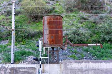 RUSTY WATER TANK IN A RAILWAY STATION