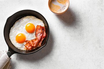 Fried eggs, bacon and coffee for breakfast