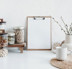 wooden clipboard with blank paper  and modern kitchen utensils table on white backdrop.Trendy Eco...