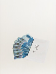 Indonesian money IDR in the envelope with THR text. THR is holiday allowance in iedul fitri or lebaran