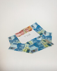 Indonesian money IDR in the envelope with THR text. THR is holiday allowance in iedul fitri or lebaran