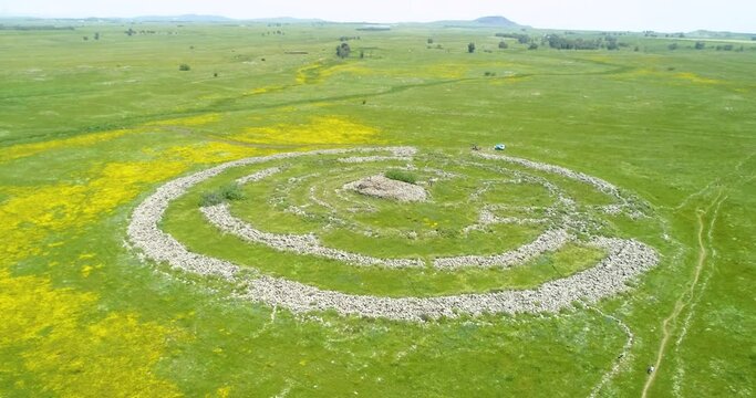 Aerial view of ancient megalithic monument in grassland, Rujum Al-Hiri, Golan Heights, Israel.