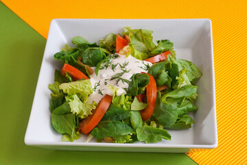 Summer lettuce with spinach, by tomatoes and sour cream. Vegan salad