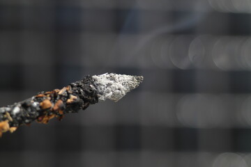 Incense burning against black background