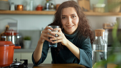 Young woman drinking glass of water