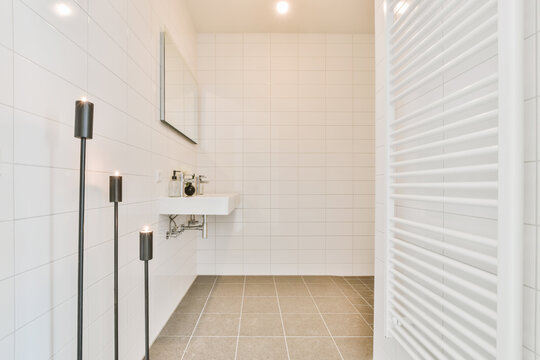 Sink near towel dryer and candlestick