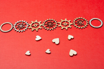 Gear wheels on red Heart shape. Valentine concept and promise of love.