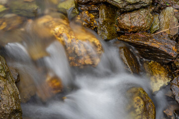Fresh color clean water in mountains creek with color stones
