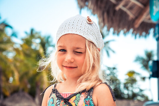 Happy cute smiling girl outdoors portrait on summer tropical background as childhood lifestyle 
