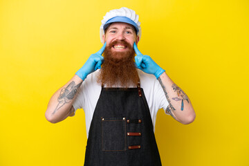 Fishmonger wearing an apron isolated on yellow background smiling with a happy and pleasant expression