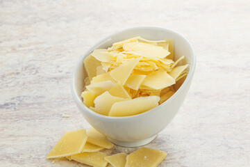 Sliced parmesan cheese heap in the bowl