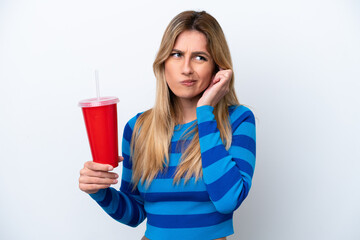 Young Uruguayan woman drinking soda isolated on white background frustrated and covering ears