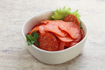 Sliced pepperoni sausage in the bowl