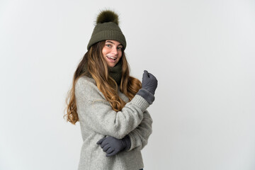 Young caucasian woman with winter hat isolated on white background celebrating a victory