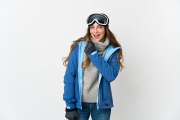 Skier girl with snowboarding glasses isolated on white background celebrating a victory