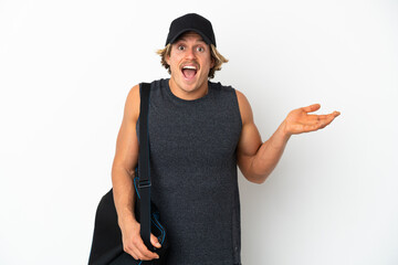 Young sport man with sport bag isolated on white background with shocked facial expression