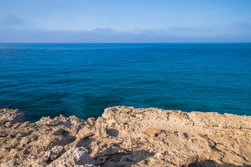 Fototapeta na wymiar Rocky coast of Cyprus island on a sunny day. Mediterranean Sea