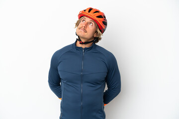 Young blonde cyclist man isolated on white background and looking up - obrazy, fototapety, plakaty
