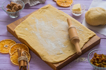 Step-by-step cooking of kraffin (or cruffin), yeast Easter cake with raisins. Step one, rolling out the dough