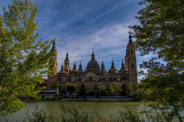 Fototapeta na wymiar spring urban landscape with pillar cathedral in Zaragoza, spain and the Ebro river