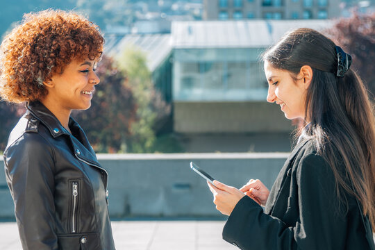 Business Woman On The Street With Device Interviewing