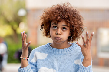 portrait of angry or furious girl in the street - obrazy, fototapety, plakaty