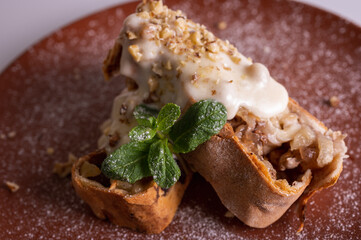 sweet apple muffins with powdered sugar and mint