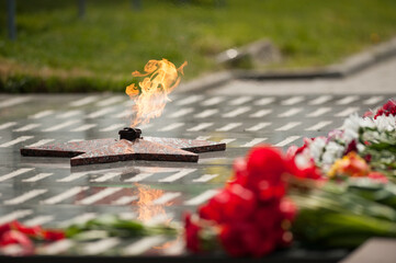 eternal flame and flowers in memory of the fallen soldiers