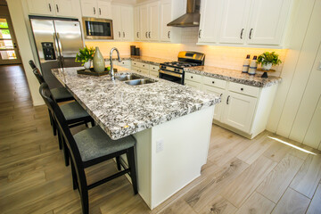 Modern Kitchen With Granite Island Counter Top And Bar Stools
