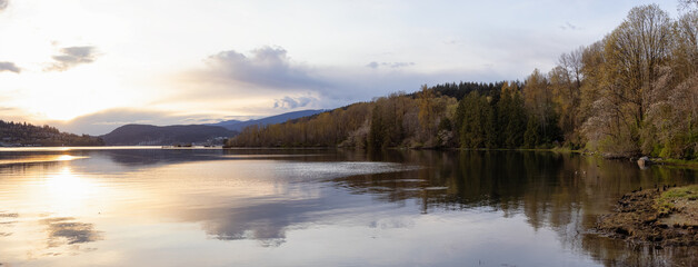 Panoramic View of a Canadian Landscape in Shoreline Trail, Port Moody, Greater Vancouver, British Columbia, Canada. Park in a Modern City during a colorful Sunset Sky. Nature Background Panorama