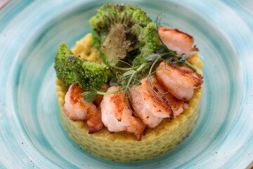 Ptitim with curry sauce shrimp and broccoli. Serving a restaurant menu dish