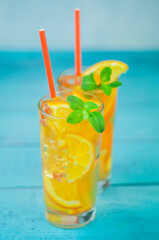 delicious refreshing cocktail drink with alcohol and orange with mint leaf