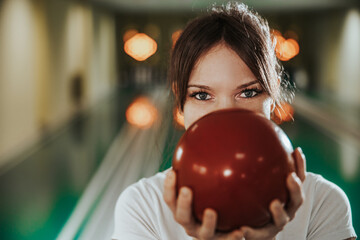 Young Woman Having Fun In A Bowling Alley - obrazy, fototapety, plakaty