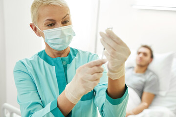 Female doctor drawing up vaccine from vial