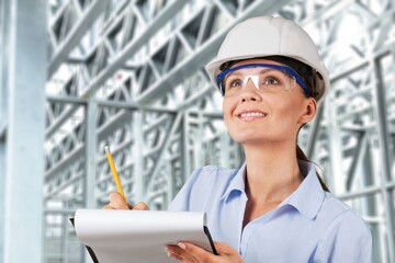 Woman engineer architect working holding blueprint construction