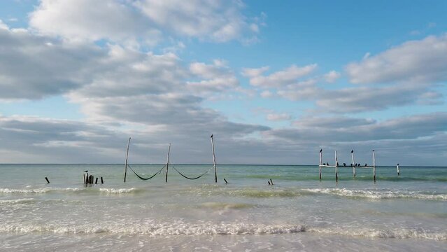 hammocks on the water at Holbox island in Caribbean sea of Mexico