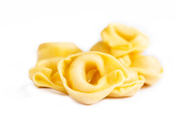 Raw fresh tortellini pasta isolated on white background - obrazy, fototapety, plakaty