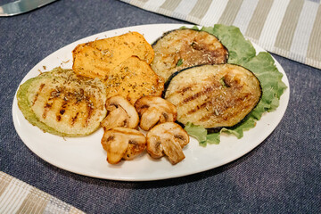 grilled mushrooms, eggplant, zucchini and bell peppers on a plate. 