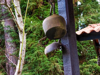 Iron pans and kitchen utensils hanging outise, in the garden