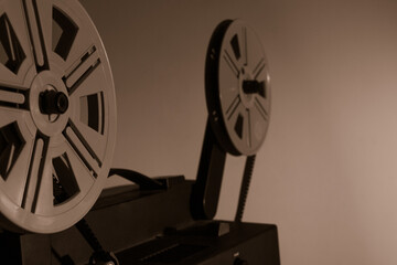 Obraz premium Old vintage 8mm projector with film reels and film frames. Copy space. Selective focus.