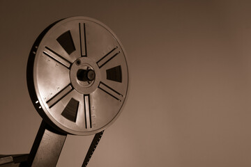 Detail of old vintage 8 mm projector with reels and film frames. Copy space. Selective focus.