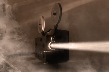 Fototapeta premium Old vintage 8mm projector with film reels and film frames. Copy space. Selective focus.