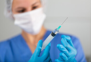 Nurse with vaccine. Nurse are showing syringe of coronavirus vaccine