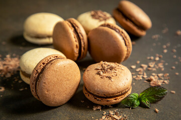 Close-up of macarons cakes of different colors in blue background. Culinary and cooking concept. Tasty colourful macaroons.