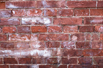an old red brick wall with streaks