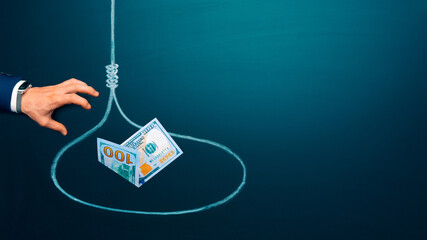 Trapped concept. US 100 dollar bill in a loop as a bait. Businessman hand trying to reach the money...
