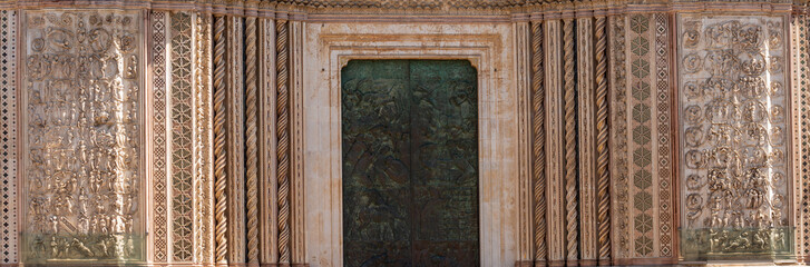 Detail of the facade famous cathedral Santa Maria Assunta made of mosaic scenes from the bible about the central square of the old city Orvieto, Duomo di Orvieto , Umbria, Italy ,Terni province