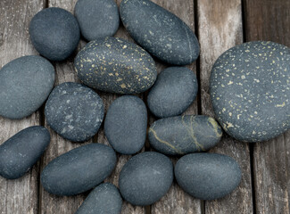 Fototapeta na wymiar Collection of black, rounded, water worn stones