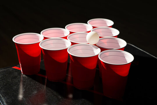 Beer pong vector pattern. Red plastic cups and ping pong ball