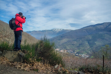 Fototapeta na wymiar Trekker man taking picture to Jerte Valley on winter, Spain